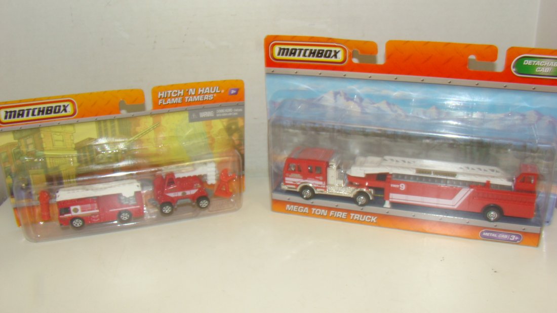 2 NIB MATCHBOX FIRE TRUCK & FLAME TAMER: NIB MATCHBOX MEGA TON FIRE TRUCK - METAL CAB - DETACHABLE CAB AND A NIB MATCHBOX HITCH 'N HAUL FLAME TAMERS - BOTH ARE DIE-CAST - GOOD CONDITION