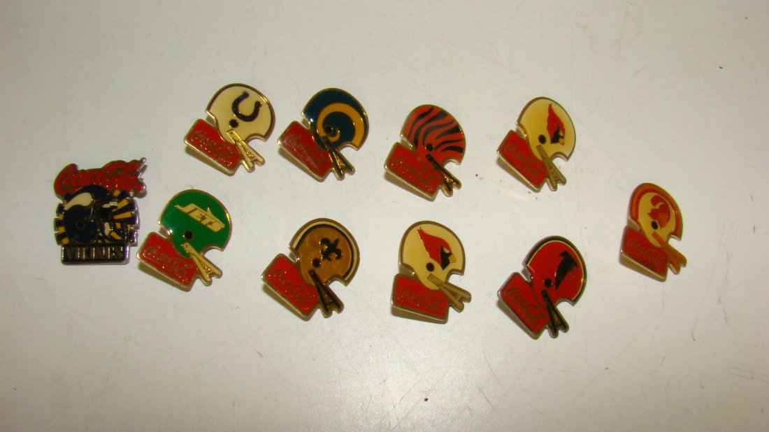10 VARIOUS COCA-COLA NFL HELMET LAPEL PINS: 10 VARIOUS COCA-COLA NFL HELMET PINS - COLTS - RAMS - BENGALS - 2 RAVENS - THE SAINTS - JETS - SEAHAWKS - BUCCANEERS AND THE VIKINGS
