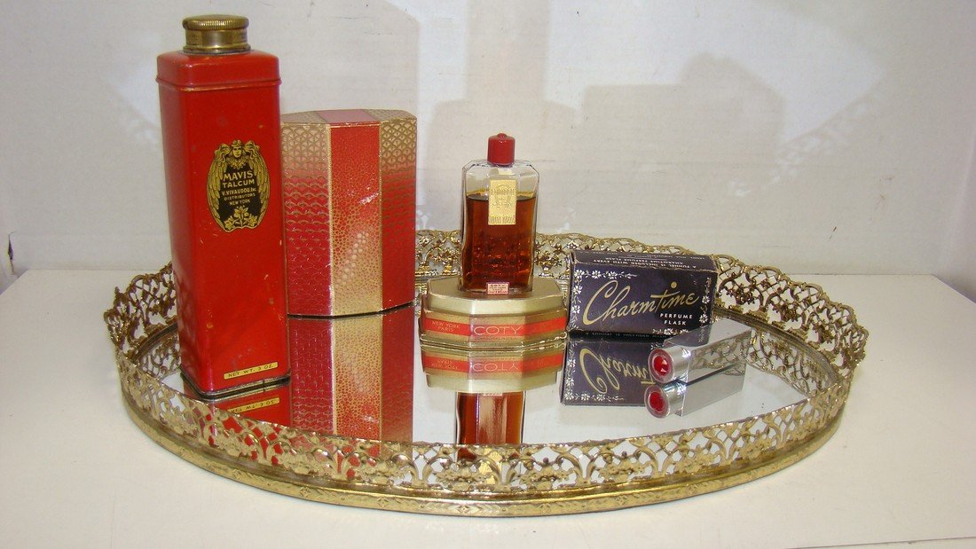DRESSER TRAY W/ VINTAGE PERFUMES: 13'' VINTAGE BRASS DRESSER TRAY WITH MIRROR BOTTOM - VINTAGE 3 OUNCE RED TIN MAVIS TALCUM POWDER BY V. VIVAUDOU INC - .80 OUNCE VINTAGE BOTTLE OF COTY LAIMONT PERFUME - DECO STYLE OUTSIDE BOX - SOME P