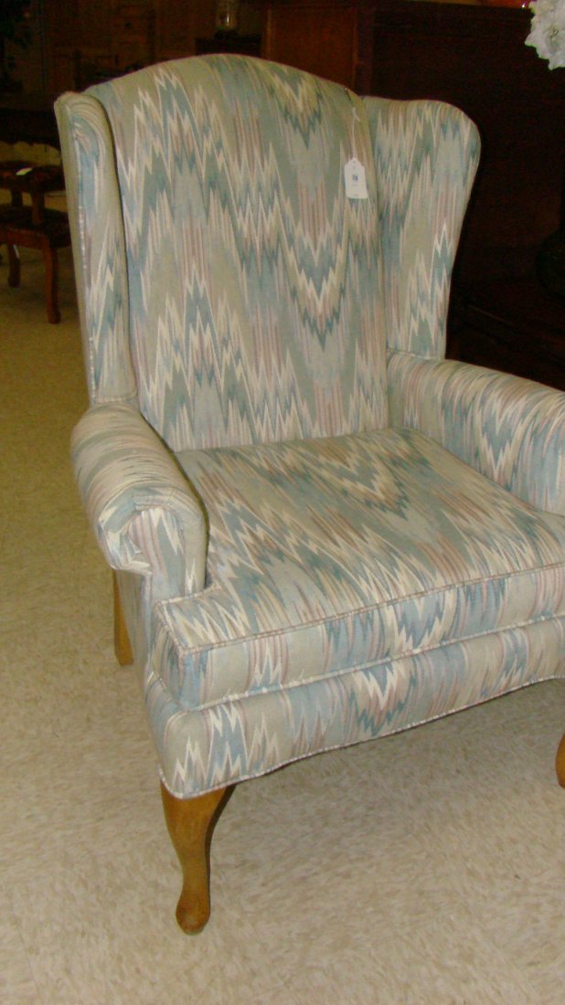 UPHOLSTERED WINGBACK CHAIR: UPHOLSTERED WINGBACK CHAIR - GEOMETRIC PASTEL PATTERN FABRIC - CARVED WOOD LEGS - LIKE NEW CONDITION - APPROX 51''x 32''x 32'' - THESE CHAIRS ARE VERY WELL MADE AND IN BEAUTIFUL CONDITION - BUYER RESP