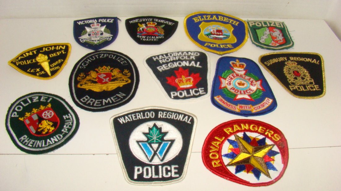 12 VARIOUS FOREIGN LAW ENFORCEMENT PATCHES: 12 VARIOUS FOREIGN LAW ENFORCEMENT SHOULDER PATCHES - VICTORIA POLICE - NEW ZEALAND TRAFFIC MINISTRY OF TRANSPORT - SAINT JOHN POLICE DEPT - POLIZEI - QUEENSLAND POLICE - SCHUTZPOLIZEI BREMEN - HALDIM