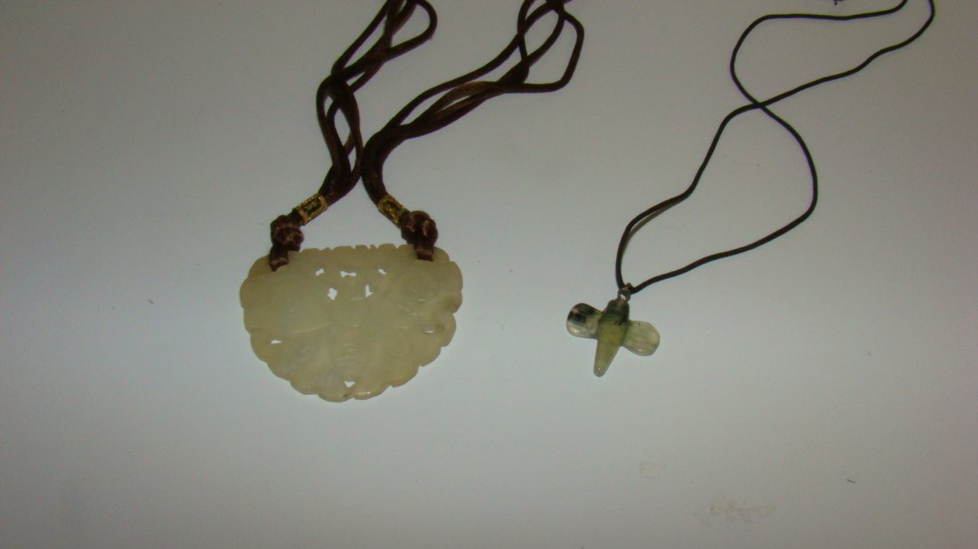 CARVED JADE PIERCED PENDANT & NECKLACE: 2''x 2.5'' CARVED AND PIERCED JADE PENDANT - BEE MOTIF - ON A 23'' BROWN WITH GOLD TONE FILIGREE TRIM AND A CARVED JADE BEE PENDANT ON A 23'' BLACK THIN CORD