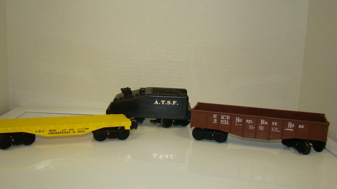 LIONEL 9024- 9031 & ATSF SLANT TENDER: LIONEL NO. 9024 C&O FLAT CAR - NO. 9031 N.K.P. GONDOLA AND AN A.T.S.F. SLANT BACK TENDER - ALL UNTESTED - FROM THE COLLECTION OF A 97 YEAR OLD CERTIFIED LIONEL REPAIR PERSON