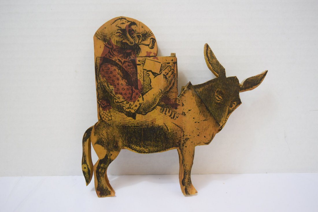ANTIQUE WOODEN NOVELTY PIECE; BURRO AND MAN: ANTIQUE WOODEN NOVELTY PIECE, BURRO AND MAN, IF YOU MOVED THE TAIL UP AND DOWN THE BURRO HEAD WOULD NOD. WOODEN PIECE BETWEEN HEAD AND TAIL IS BROKEN. AS IS APPROXIMATELY 7.5 INCHES IN HEIGHT.