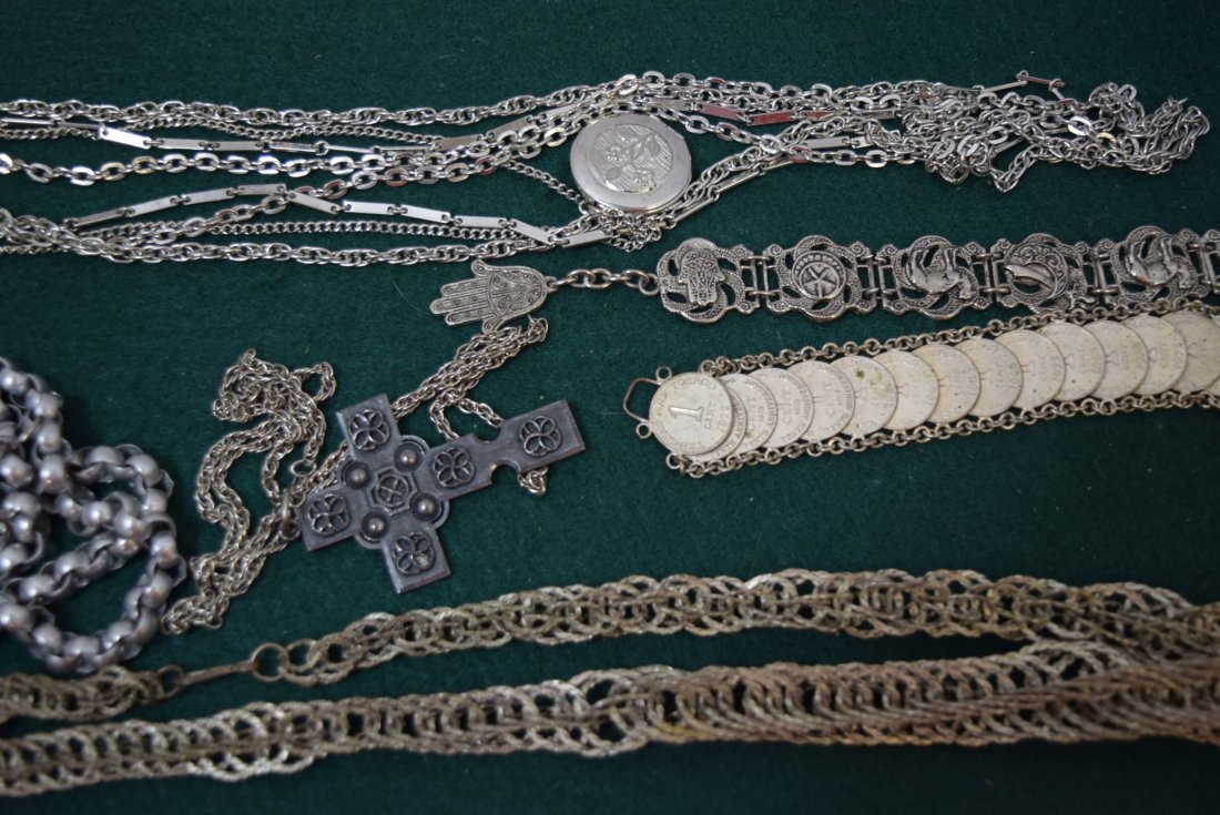 TRAY LOT COSTUME SILVER TONED JEWERLY: TRAY LOT COSTUME SILVER TONED JEWELRY. 4 NECKLACES, TWO BRACELET - CAMELS, COINS. FOUR LONG NECKLACES- ONE LOCKET, ONE CROSS AND MORE.