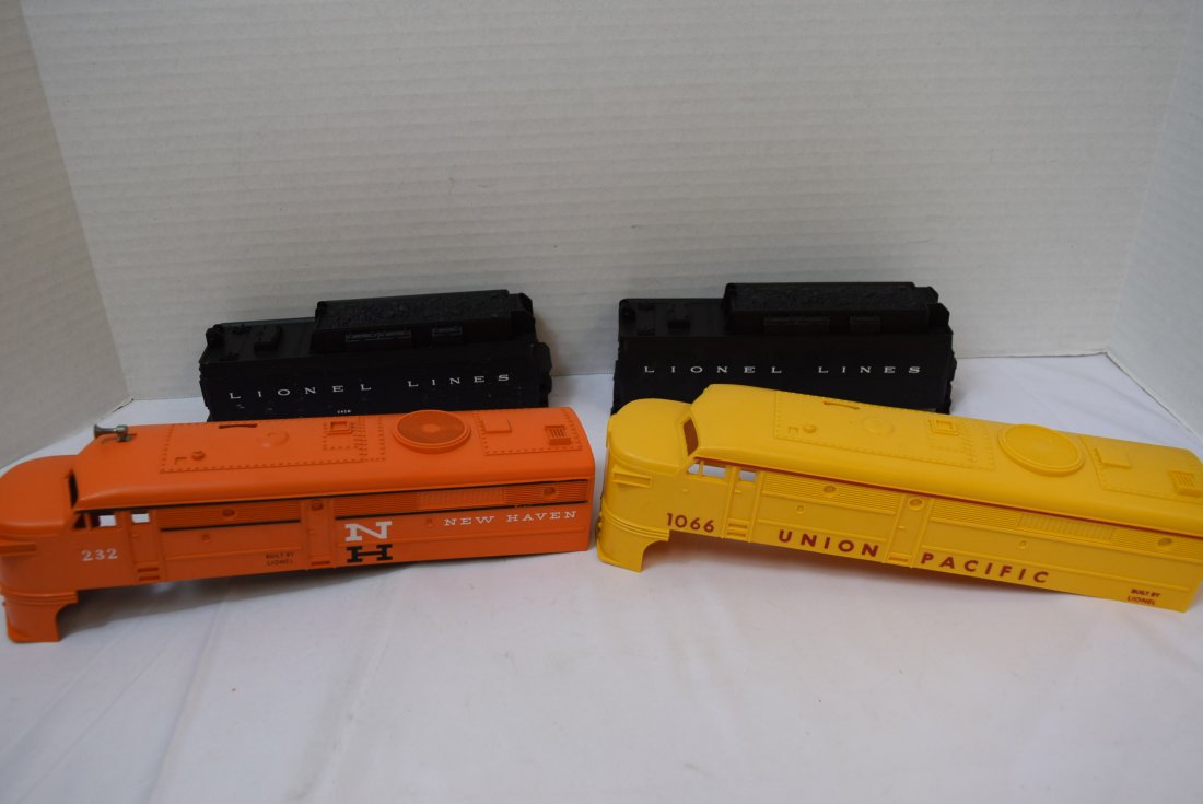 4 LIONEL CAB COVERS: 4 LIONEL CAB COVERS. LOCOMOTIVE ORANGE NEW HAVEN #232, LOCOMOTIVE YELLOW UNION PACIFIC #1066 AND 2 TENDER BLACK LIONEL LINES #243W. THEY SEEM IN NEW CONDITION.