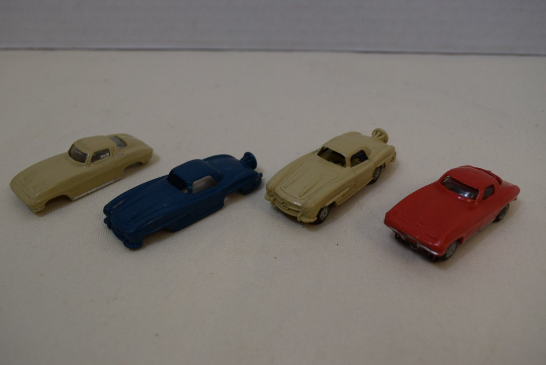 VINTAGE SLOT CARS BY LIONEL; MERCEDES AND CORVETTE: VINTAGE SLOT CARS BY LIONEL, MERCEDES AND CORVETTES. 2.75 INCHES IN LENGTH. RED, BLUE AND TAN IN COLORS. 2 SLOT CARS WITH 2 EXTRA BODIES. ONE CAR IS MISSING ONE OF IT'S METAL RAILS UNDERNEATH. UNTESTE
