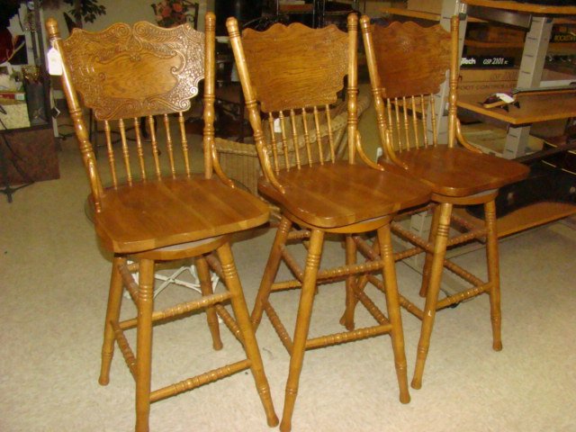 THREE OAK SWIVEL BAR STOOLS (1 of 2)