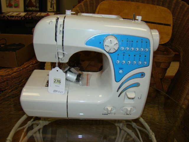 SEWING MACHINE: SEWING MACHINE-WHITE WITH BLUE FRONT-PICTURE STITCH DESIGNS FOR EASY CHOOSING- UNKNOWN MAKER- APPEARS COMPLETE1/6/17: THE PICTURE HAS BEEN CORRECTED.