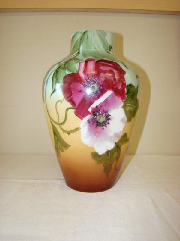 HAND PAINTED WHITE MILK GLASS VASE: HAND PAINTED OVER A 12.5''H WHITE MILK GLASS VASE- THREE TONE BACKGROUND OF GREEN-TAN-BROWN WITH RED & WHITE FLOWERS WITH DARKER BREEN LEAVES - MINOR CHIPS ALONG RIM OF VASE-UNSIGNED