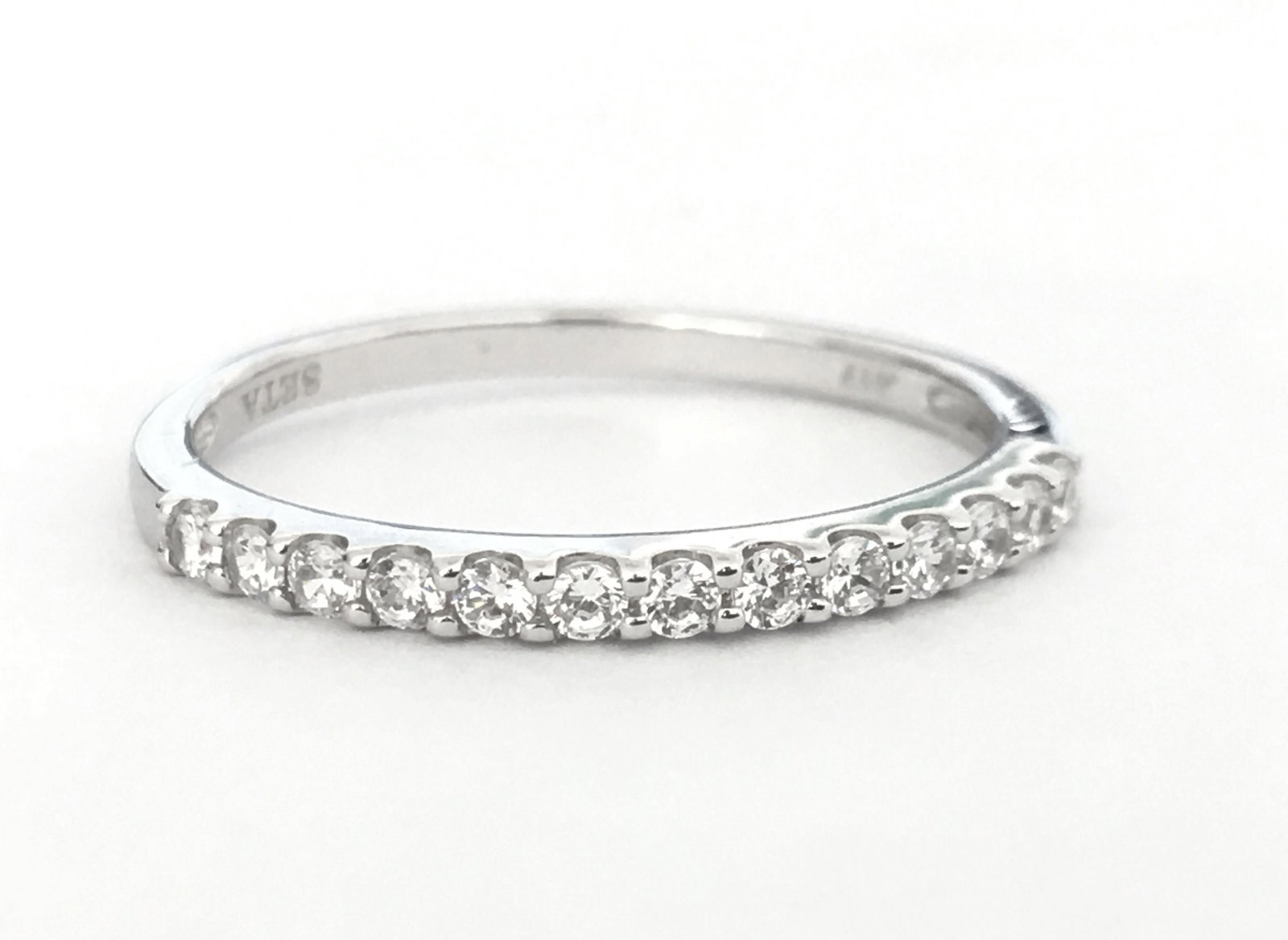 Conflict Free Diamonds & White Gold Engagement Ring: Solid 10k white gold. Total number of diamonds in the ring: 13. Total weight of the ring: 1.70 grams. Round brilliant cut American diamonds set in prongs. Has .417 hallmark on the metal. Beautiful cub