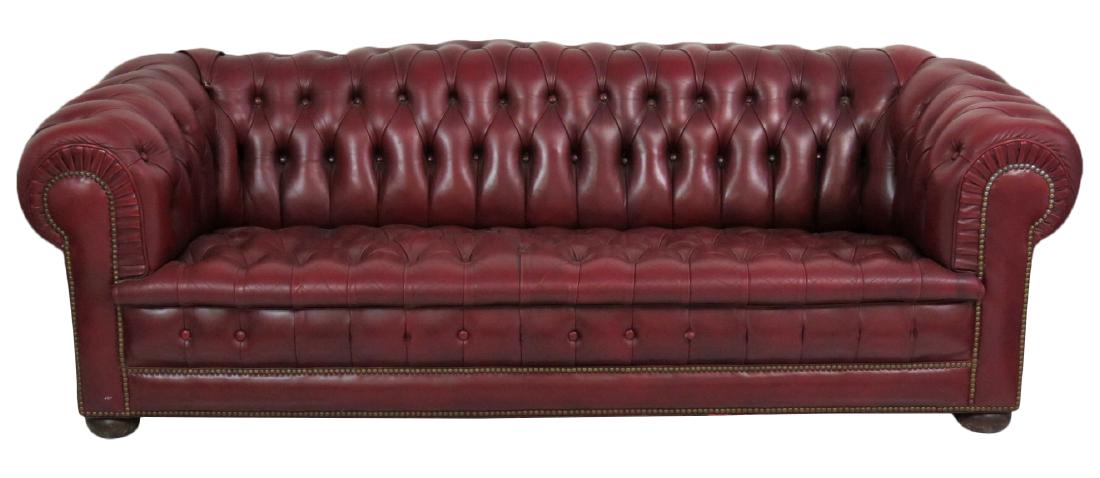 TUFTED LEATHER CHESTERFIELD SOFA: Red leather tufted upholstery. Bun feet. 28"h. x 84"w. x 34"d.