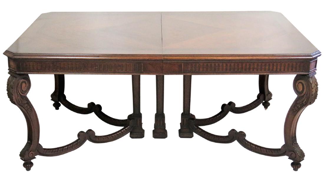 REGENCY STYLE INLAID DINING TABLE: Carved base with plumes. Inlaid top with parquetry inlay. 31"h. x 69 1/2"w. x 44"d. Four 12"w. leaves. Two with skirts.