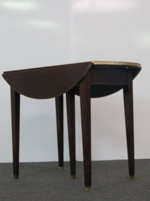 JANSEN STYLE DROPLEAF DINING TABLE: Drop leaf extension table with four 13 1/2" leaves and center support leg. Brass accents. 29"h x 38"w x 20 1/2" d with sides down. 33 1/4" w with sides up. Opens to 87 1/2".