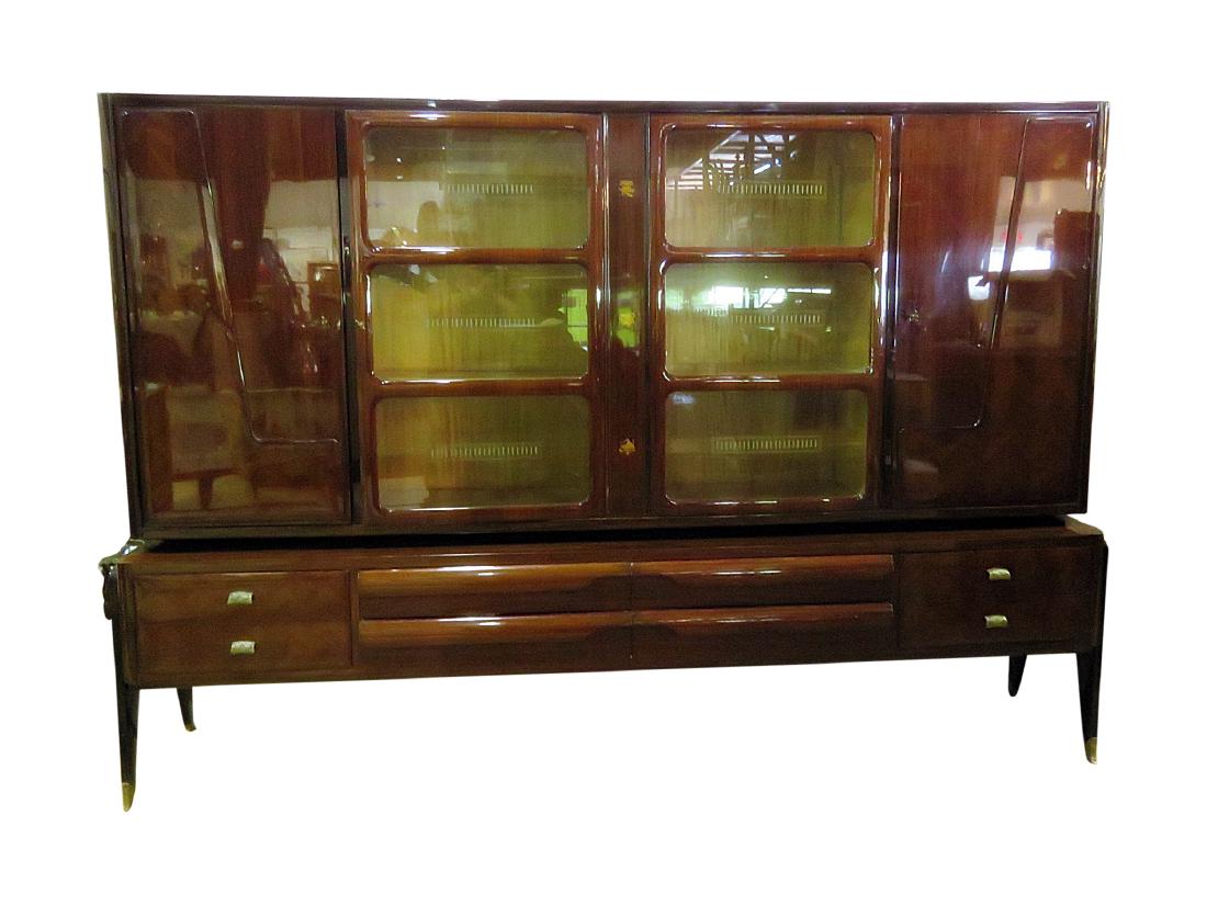 ITALIAN ROSEWOOD VENEER BREAKFRONT: Etched glass on doors. Two glass doors. Two wooden doors each containing two shelves. With keys. Eight drawers. Inlaid. One piece. Disassembles. Brass feet and pulls. 72" h x 105 3/8" w x 19 3/4" d.