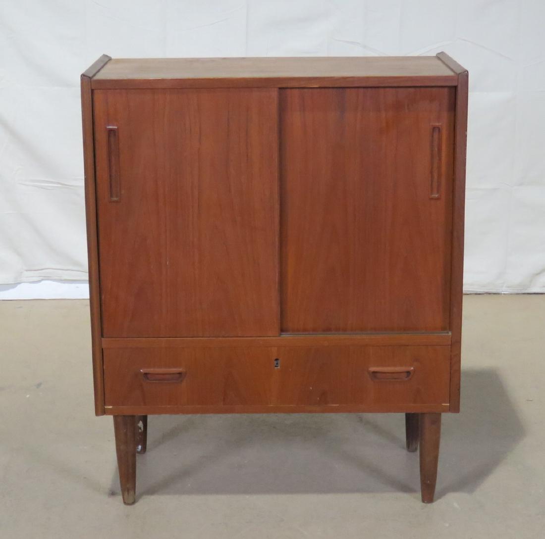 TEAK CABINET: 2 sliding doors over 2 drawers. Dovetailed. 36" h x 29 1/2" w x 15 1/2" d.