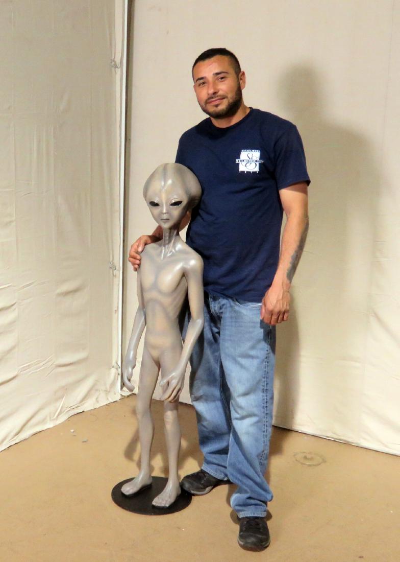 LIFESIZE ALIEN STATUE: Some kind of molded material. On metal stand. 48" h x 11 1/4" w x 11 3/4" d.