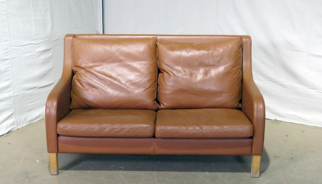 DANISH LEATHER LOVESEAT: Wood legs. Leather upholstery. 32 1/2" h x 65" w x 32" d. 15" seat height.