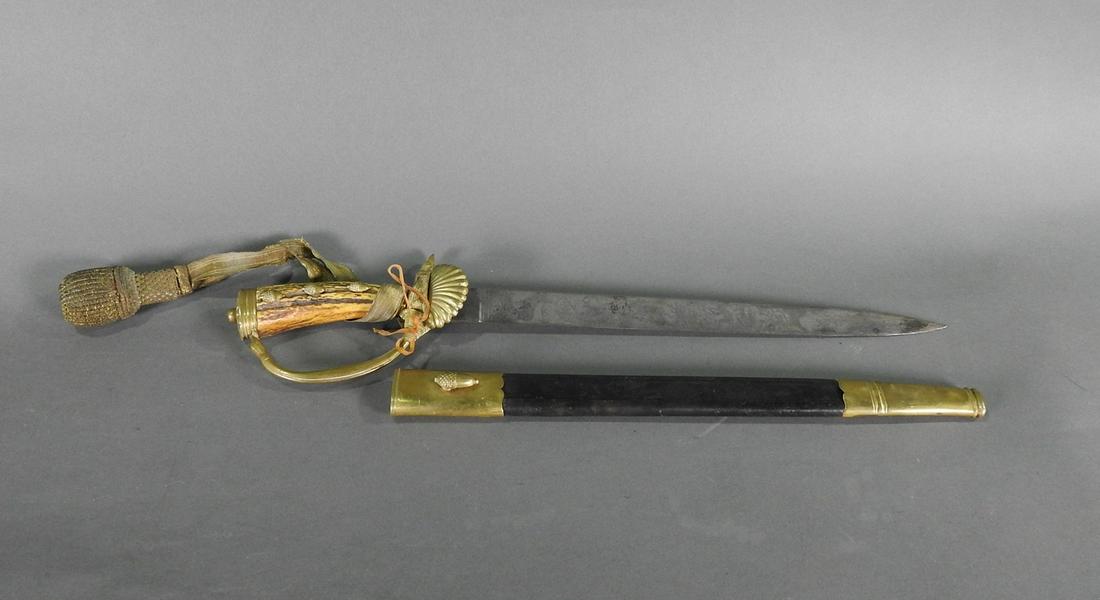 GERMAN HUNTING SWORD: Logo Squirrel "CE". German decorated blade with stags. Brass and leather scabbard. Stag handle with brass acorns. Ges Geschitz. 19 3/4" h x 4" w x 1 1/2" d.