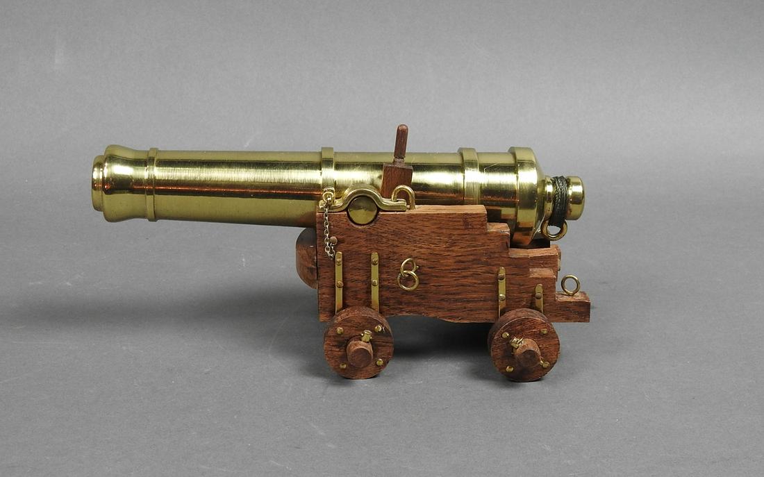 MINITURE BRASS AND WOOD SHIPS CANNON: Brass and wood cannon. Functioning wheels. 3 3/4" h x 4 1/2" w. x 8 7/8" d.