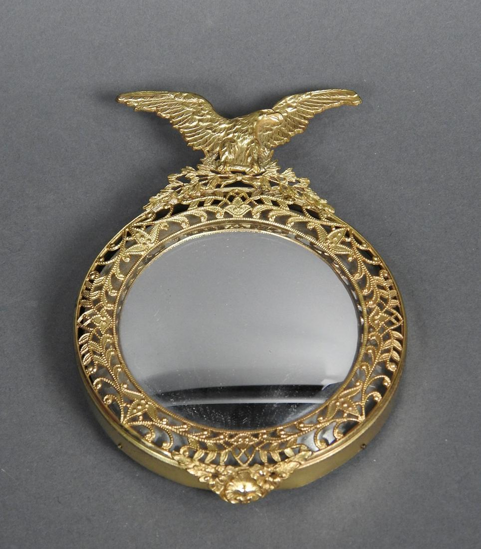 MINIATURE BULLSEYE MIRROR W/BRASS: Small scale bull's eye mirror with brass eagle and filigree. 5 1/2" h x 4" w x 1/2" d