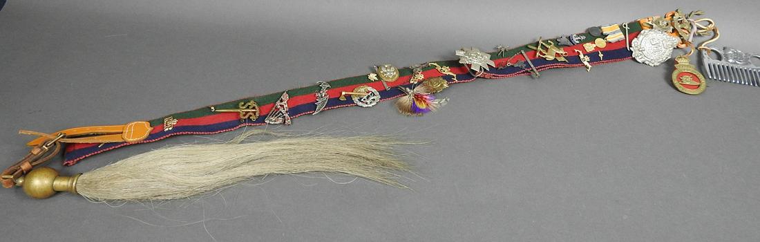 VINTAGE BRITISH MILITARY BELT W/MEDALS: Striped fabric belt w/brass detail and horsehair. Embellished/decorated with 30+ badges. 39 3/4" h x 2 1/4" w