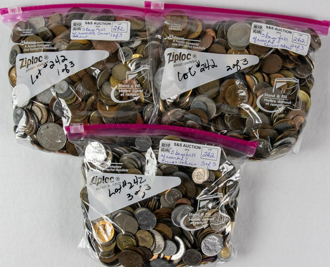 3 BAGS FULL OF ASSORTED COINS AND TOKENS FROM AROUND (1 of 2)