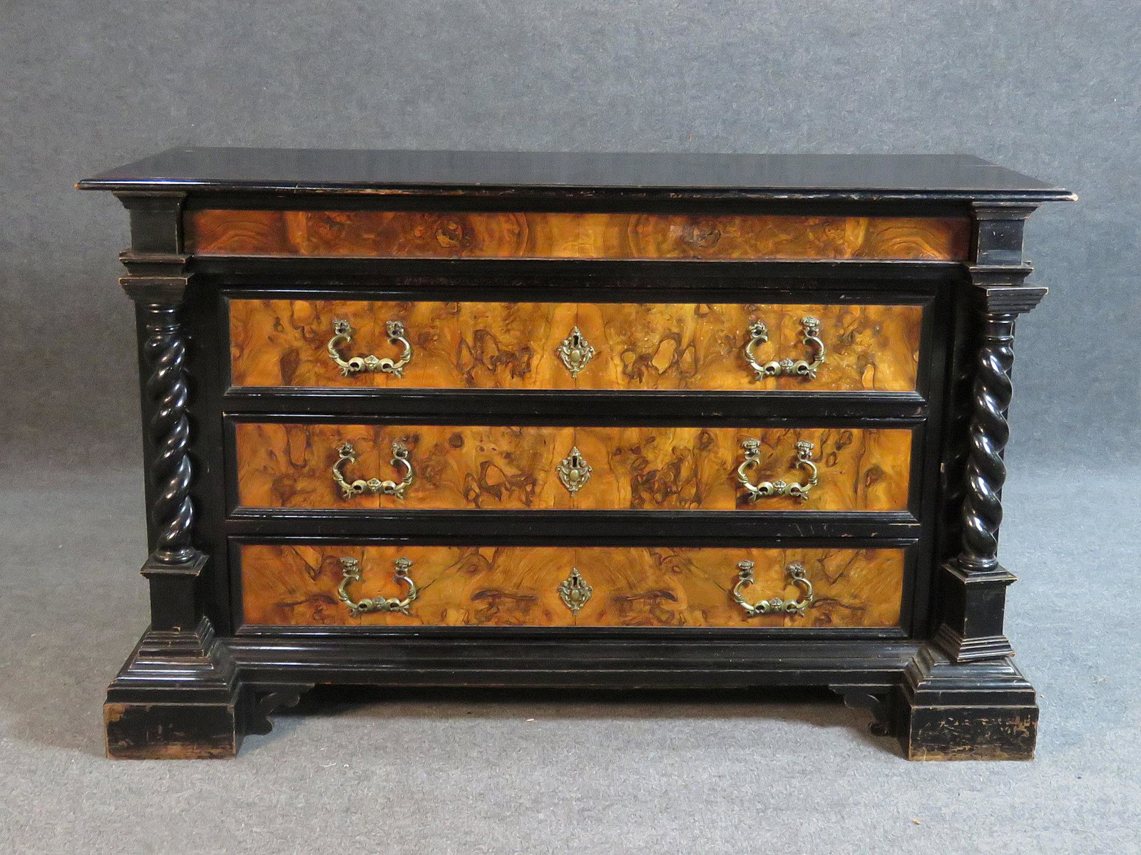 ITALIAN BAROQUE BURLED WALNUT COMMODE/DRESSER: Burled walnut. Ebonized. Four drawers. Carved. Dovetailed. 6 pull out drawers on sides. 37 1/2" h x 61 3/4" w x 26 3/4" d.