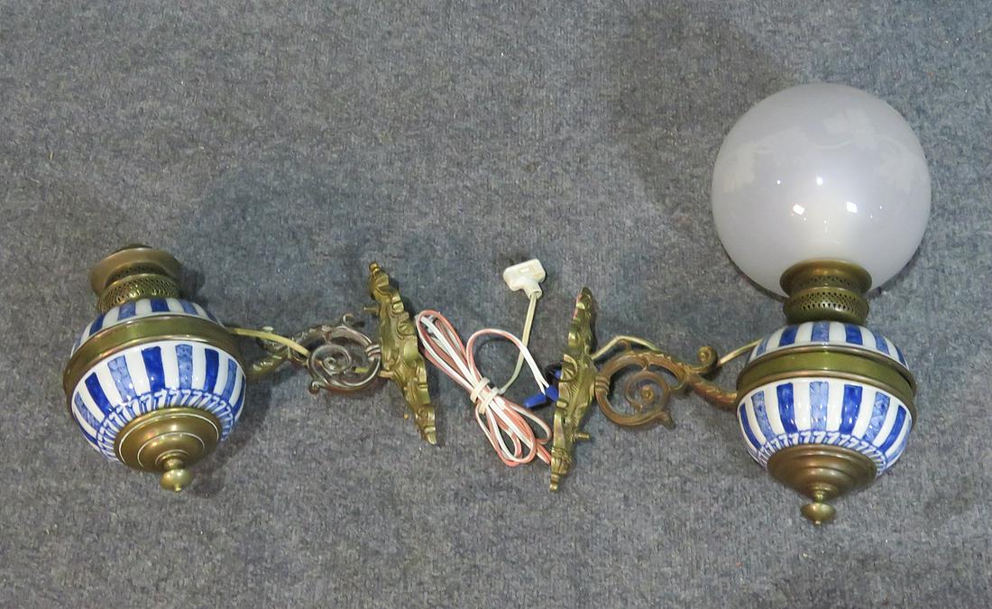 PAIR CERAMIC AND BRASS WALL SCONCES: Ceramic inserts. Brass accents. Only has one glass shade. Measures 16 1/2" h (with shade) x 7 1/2" w x 12 1/2" d.