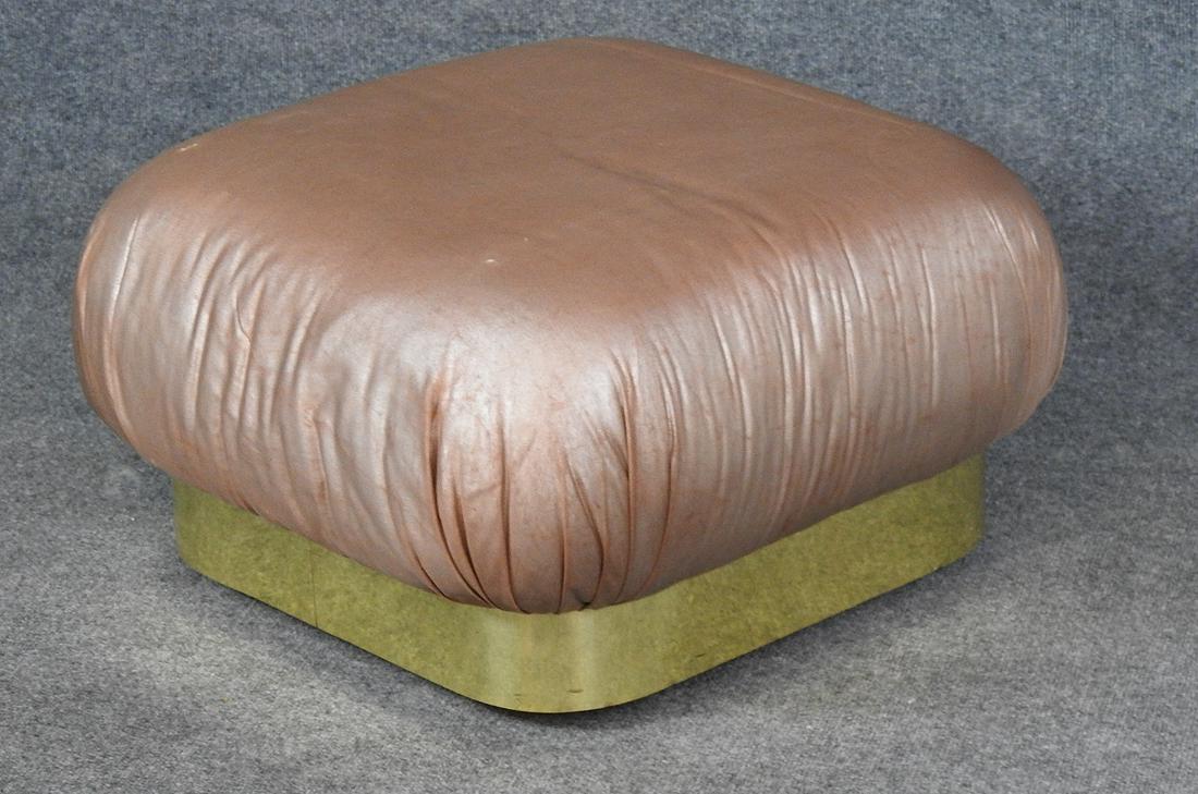 KARL SPRINGER POOF OTTOMAN: Brass banded base on wheels. Wine colored fabric. 13" h x 25" w x 25" d.