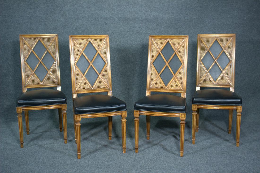 4 TOMMI PARZINGER STYLE CHAIRS: Walnut frames with diamond form panels surrounded by caned panels. Black vinyl upholstery. 43" h x 19" w x 22" d. Seat height 20".