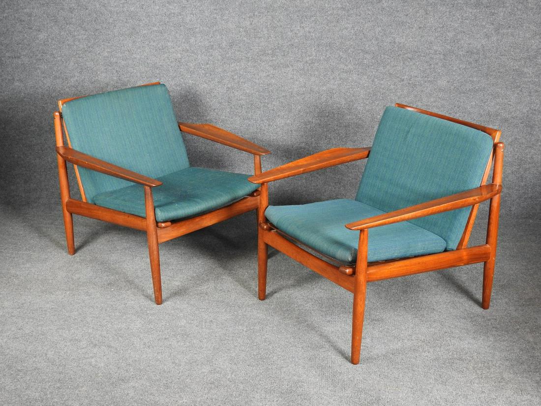 PAIR GLOSTRUP MOBELFABRIK DANSIH TEAK ARM CHAIRS: Teak frames with blue and green upholstered cushions. 27 1/2" h x 28 3/4" w x 29 1/2" d. Seat height 16".