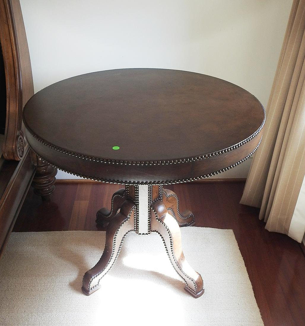 LEATHER DRUM TABLE: Leather wrapped. Nail head trim. 28 1/2" h x 22" diameter.
