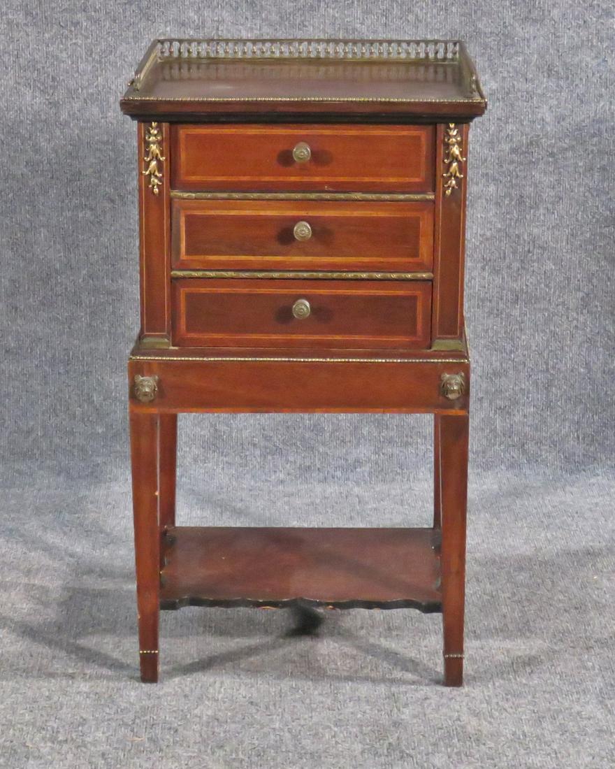WALNUT NIGHTSTAND: Gallery top. 3 dovetailed drawers. Inlaid. Brass accents. 28 1/2" h x 15 1/2" w x 11 1/4" d.