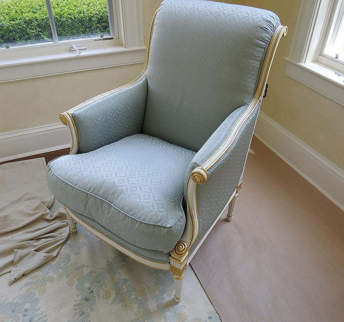 LOUIS XVI STYLE BERGERE: Upholstered. Gilt accents. Distressed paint. 39 1/4" h x 27 1/4" w x 33" d. Seat height 20".