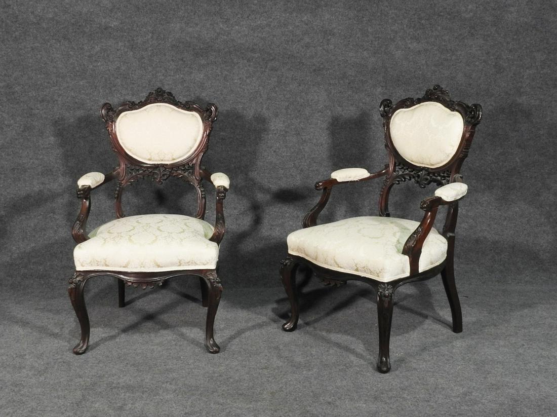 PAIR EDWARDIAN STYLE ARM CHAIRS: Mahogany frame. Upholstered seat and back. Carved. 36 1/2" h x 20 1/2" w x 21" d. Seat height 16 1/2".