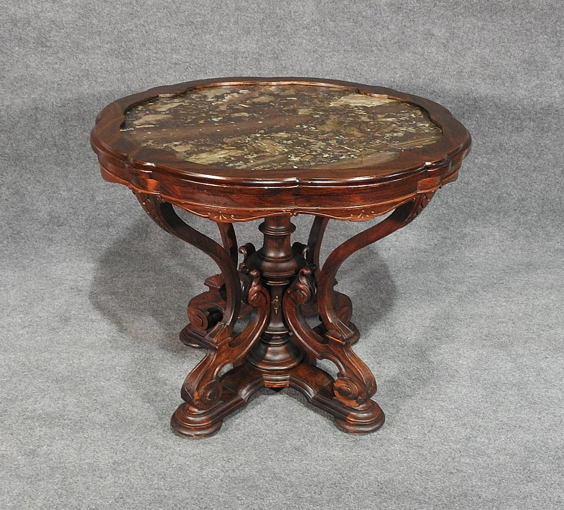 VICTORIAN ROSEWOOD MARBLETOP CENTER TABLE: Marble top. Rosewood. Carved. 29" h x 35" w x 35" d.