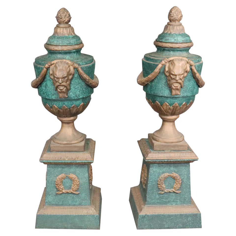 PR FAUX MALACHITE & FAUX BRONZE URNS: Cast iron. 1900's era. Painted. Comes apart. 50" h x 14 1/2" w x 14 1/2" d.