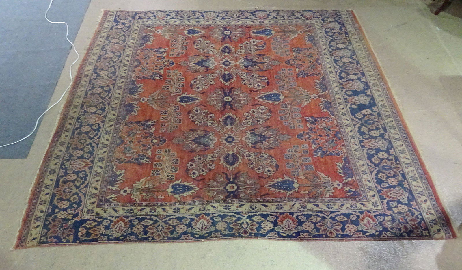 ANTIQUE PERSIAN RUG: Red, blue and tan. 107" x 102 1/2"