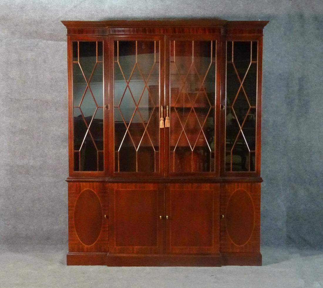 BAKER 2PC MAHOGNAY CHINA: Historic Charleston Reproductions. Mahogany. 2 piece. 4 glass doors on top containing 3 glass shelves. Bottom has 4 doors. Center doors contain one drawer and one shelf. Side doors contain one shelf. 