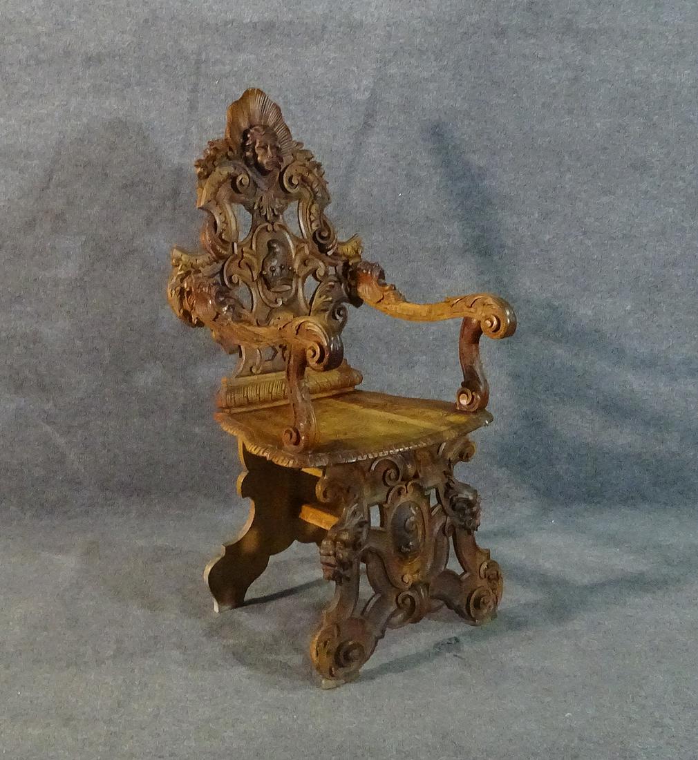 ITALIAN RENAISSANCE STYLE CORNER CHAIR: Carved. Walnut. 48 1/2" h x 25" w x 24" d. Seat height 19 3/4".
