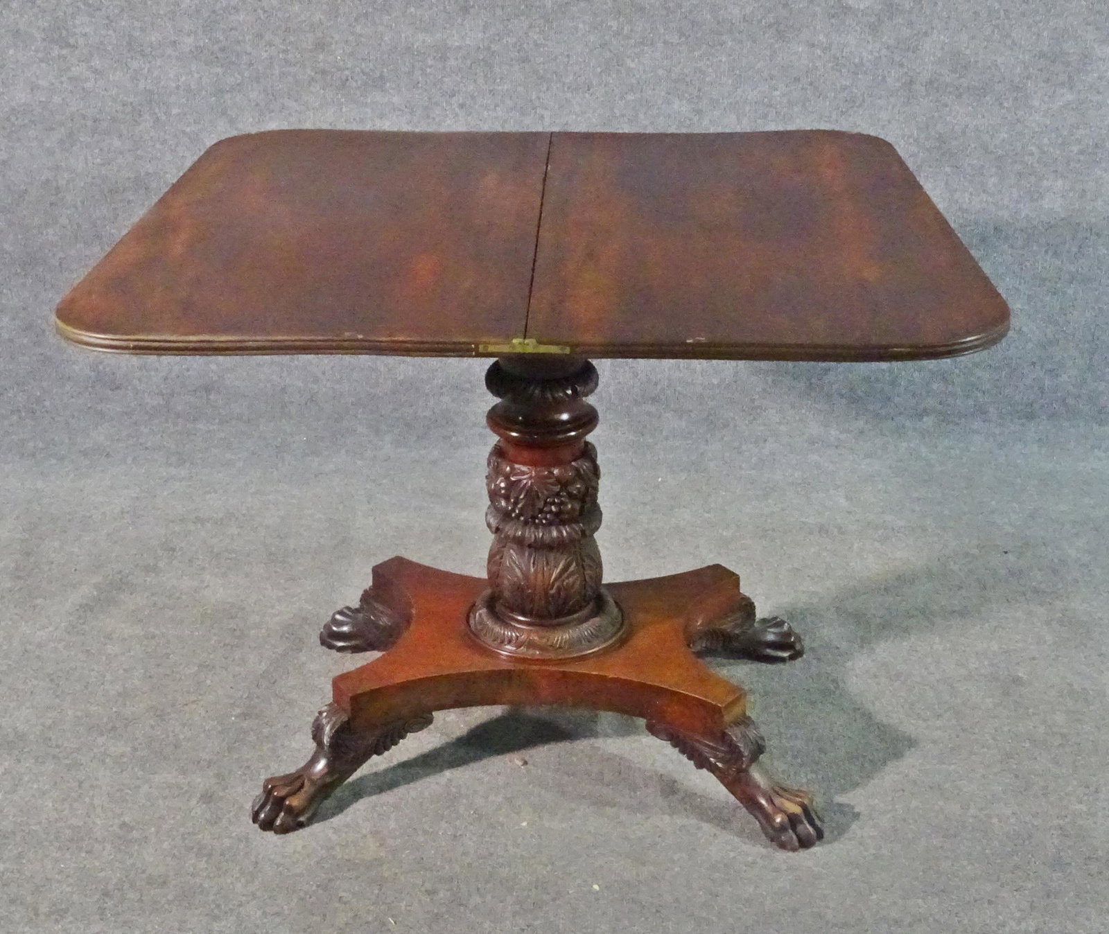 AMERICAN EMPIRE FLIP TOP END TABLE: Mahogany. Inlaid top. Carved corners and base. Claw foot. 28 1/2" h x 36" w x 18 1/4" d.