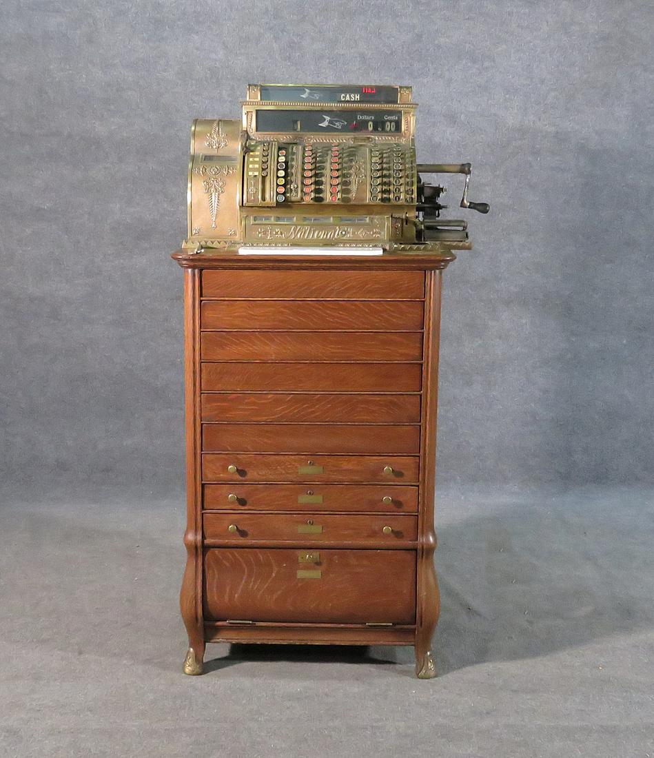 ANTIQUE NATIONAL CASH REGISTER: Bronze register. Oak stand. Metal pulls and accents. 26 1/2" h x 33" w x 21" d.