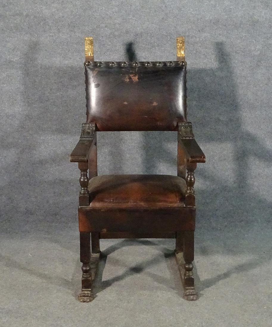 CONTINENTAL THRONE CHAIR: Wood frame. Leather upholstery. Nail head trim. Gilt accents. Carved. 52" h x 25" h 25 1/2" d. Seat height 21 1/2".