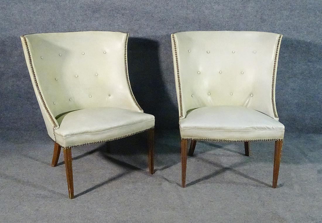 PAIR WING BACK CHAIRS: Vinyl upholstery. Nail head trim. Button back. Wood legs. 37 1/4" h x 29 3/4" w x 28 1/2" d. Seat height 18".
