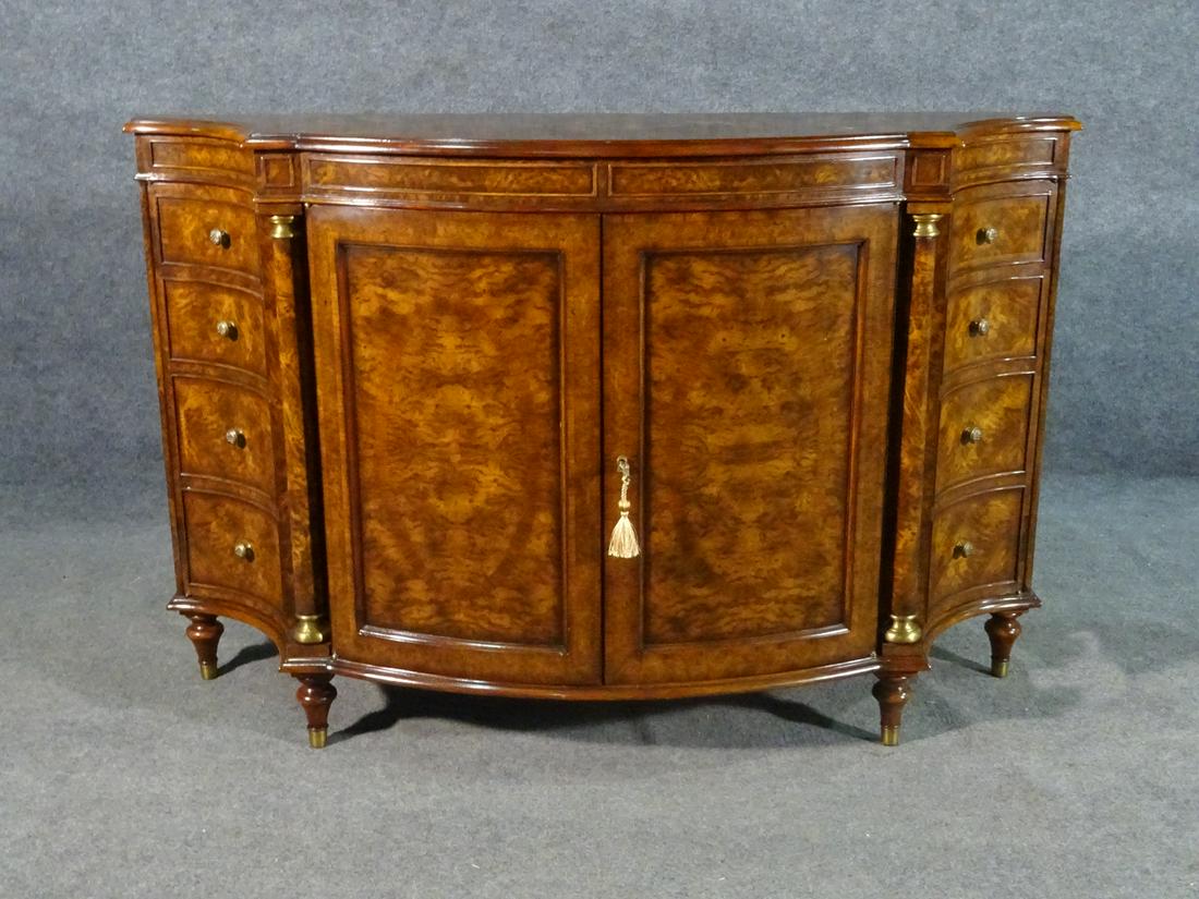 THEODORE ALEXANDER BURL WALNUT SIDEBOARD: Signed. Burl walnut. 2 faux door side doors. 2 center doors. Brass foot caps and hardware. 35 1/2" h x 53 1/4" w x 16" d.