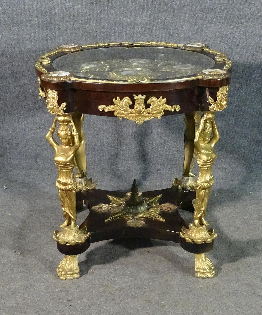 LOUIS XV STYLE BRONZE FIGURAL CENTER TABLE: Bronze mounting with bronze figures. Glass top with porcelain inserts. 27 1/2" h x 30" diameter.