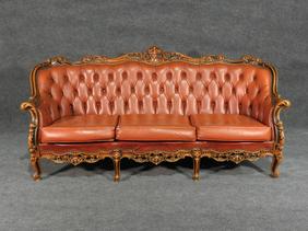 LOUIS XV STYLE CARVED SOFA: Carved wooden frame. Tufted back. Vinyl upholstery. Nail head trim. 37 1/2" h x 78" w x 33 1/2" d.