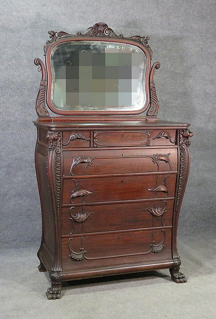 RENAISSANCE STYLE HIGH CHEST W MIRROR ATTR HORNER: Carved. Swing mirror. Claw feet. Mahogany. Lions heads. Beveled glass. 7 dovetailed drawers. 76" h x 42 1/2" w x 22 5/8" d.