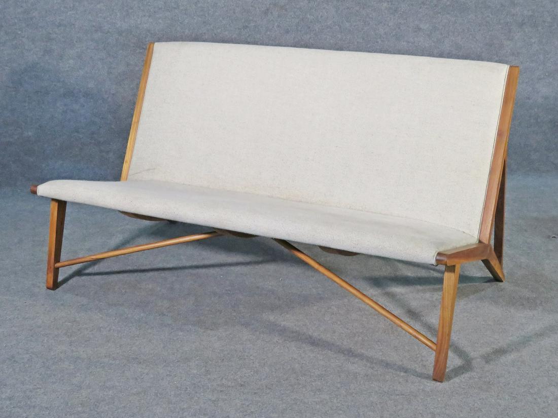 SETTEE AFTER HANS WEGNER: Wood frame. Upholstered back and seat. 31" h x 57 1/4" w x 32" d. Seat height 16 3/4".